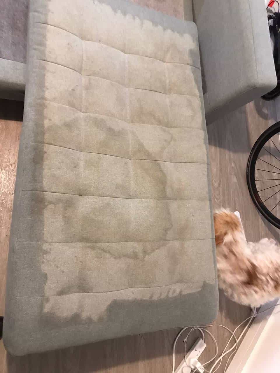 This is a BEFORE photo of a Grey sofa that has lots of stains on it. The sofa is just about to be cleaned by The K&S Carpet Cleaners. The photo was taken in Kent | Sussex