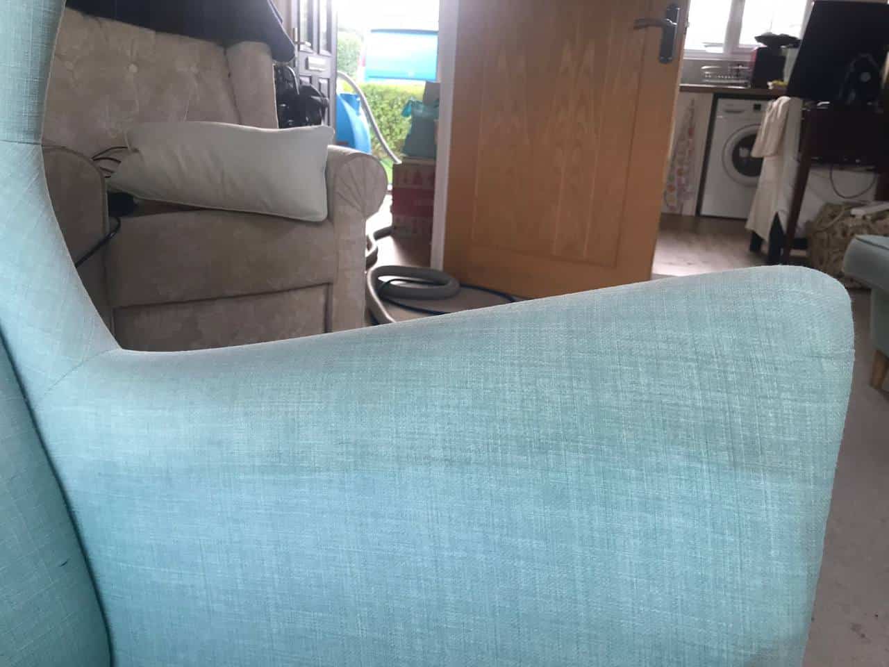 This is a phot of the arm of a blue sofa that has been partly cleaned by steam cleaning. Works carried out by The K&S Carpet Cleaners in Kent Photo taken in Kent | Sussex